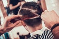 Stylish haircut for a man in a barbershop.