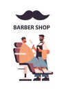 Stylish hairdresser cutting hair of client male barber in uniform trendy haircut barbershop concept