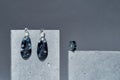 Stylish handmade set of a ring and dangle teardrop earrings made of dark blue epoxy resin with silver foil inside on