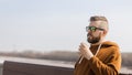 Stylish handsome hipster man holding drinks cocktail, spring time. Banner with copy space and place for advertising Royalty Free Stock Photo
