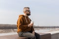 Stylish handsome hipster man holding drinks cocktail, spring time. Copy space Royalty Free Stock Photo