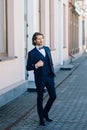 Stylish handsome man with beard, wearing suit jacket and shirt, outdoors on the city street Royalty Free Stock Photo