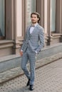 Stylish handsome man with beard, wearing suit jacket and shirt, outdoors on the city street Royalty Free Stock Photo