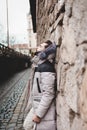 Stylish handsome man with a beard in a winter jacket with fur posing outdoors. Portrait of an elegant guy in beautiful clothes Royalty Free Stock Photo