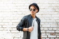 Stylish handsome man with sunglasses and a black hat Royalty Free Stock Photo