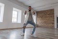 Stylish handsome young dancer in a jacket and ripped jeans