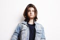 Stylish handsome young man posing on jeans jacket. Studio shot on white background Royalty Free Stock Photo