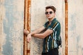 Stylish handsome young man with sunglasses in a fashion beach Royalty Free Stock Photo