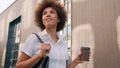 Stylish happy African American businesswoman holding coffee cup take away drink attractive girl in city business woman Royalty Free Stock Photo