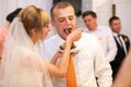 stylish happy bride and groom cutting and tasting fabulous wedding cake in a restaurant Royalty Free Stock Photo