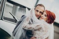 Stylish happy bride and groom embracing under veil, and smiling near retro car. luxury wedding couple newlyweds, happy emotional Royalty Free Stock Photo