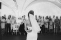 Stylish happy bride and groom gently dancing at wedding reception. Gorgeous wedding couple of newlyweds embracing while having Royalty Free Stock Photo