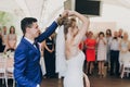 Stylish happy bride and groom gently dancing at wedding reception. Gorgeous wedding couple of newlyweds embracing while having Royalty Free Stock Photo