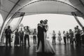 Stylish happy bride and groom gently dancing at wedding reception. Gorgeous wedding couple of newlyweds embracing while having Royalty Free Stock Photo