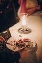 Stylish happy bride and groom tasting together wedding cake with fruits at wedding reception outdoors in the evening. Couple Royalty Free Stock Photo