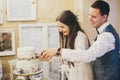 Stylish happy wedding couple cutting together modern cake with lavender in stylish restaurant. Provence wedding reception. Royalty Free Stock Photo