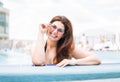 Stylish happy young woman plus size body positive in black swimsuit and sunglasses enjoying her life in the hotel pool, summer Royalty Free Stock Photo