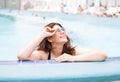 Stylish happy young woman plus size body positive in black swimsuit and sunglasses enjoying her life in the hotel pool, summer Royalty Free Stock Photo