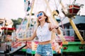 Stylish happy young woman wearing short denim shorts and a white T-shirt. brightred lips . portrait of smiling girl in sunglasses Royalty Free Stock Photo