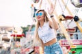 Stylish happy young woman wearing short denim shorts and a white T-shirt. brightred lips . portrait of smiling girl in sunglasses Royalty Free Stock Photo