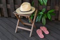 Stylish hat and flip flops near wooden fence. Beach accessories Royalty Free Stock Photo