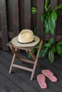 Stylish hat and flip flops near wooden fence. Beach accessories Royalty Free Stock Photo