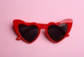 Stylish heart shaped sunglasses, top view. Fashionable accessory