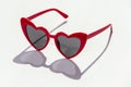 Stylish heart shaped sunglasses on white