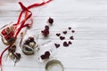 stylish hearts in glass jar and roses and ribbons on white wooden background. unusual happy valentines day concept. greeting card Royalty Free Stock Photo