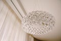 Stylish hi-tech chandelier made of transparent acrylic balls. White light interior style.