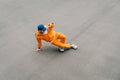 Stylish hip hop dancer dancing break on paved playground, street dancing concept. Young man in bright casual clothes shows hip hop Royalty Free Stock Photo