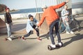 Stylish hipster boy riding gyroboard with friends near by