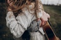 stylish hipster couple embracing in windy field. boho gypsy woman and man with guitar strongly hugging. atmospheric motion moment