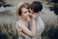 Stylish hipster couple hugging at lake. man and woman in modern