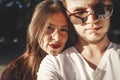 Stylish hipster couple making selfie and embracing in sunlight. Happy family couple in love making self portrait and smiling in Royalty Free Stock Photo