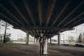 Stylish hipster couple posing under abandoned bridge. boho gypsy