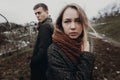 stylish hipster couple posing in windy autumn park. beautiful woman portrait. space for text. creative photo. sensual atmospheric