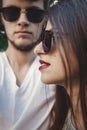 Stylish hipster couple in sunglasses posing and making cool selfie. Happy family couple in love making self portrait and embracing Royalty Free Stock Photo