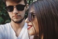 Stylish hipster couple in sunglasses posing and making cool selfie. Happy family couple in love making self portrait and embracing Royalty Free Stock Photo