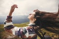 Stylish hipster girl with backpack and windy hair on top of mountains. Portrait of happy young woman relaxing. Carefree mood. Royalty Free Stock Photo