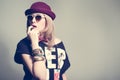 Stylish hipster girl posing in studio wearing hat Royalty Free Stock Photo