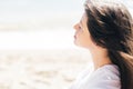 Stylish hipster girl relaxing on beach. Summer vacation. Portrait of  happy boho woman enjoying time and smiling at windy sea. Royalty Free Stock Photo