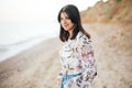 Stylish hipster girl walking on beach at sea. Calm portrait of happy fashionable boho woman relaxing at sandy cliff on tropical Royalty Free Stock Photo