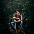 stylish hipster lumberjack with ax in the sunny forest in mountains Royalty Free Stock Photo