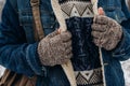 Stylish hipster traveler with backpack posing in cool sweater an