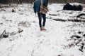 Stylish hipster traveler walking in nubuk shoes in winter snowy