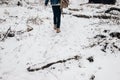 Stylish hipster traveler walking in nubuk shoes in winter snowy