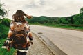 stylish hipster woman with backpak walking and looking at mountains, summer travel concept, space for text Royalty Free Stock Photo