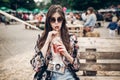 Stylish hipster woman drinking lemonade. cool boho girl in denim