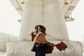 Stylish hipster woman having fun, in hat with windy hair near ri Royalty Free Stock Photo